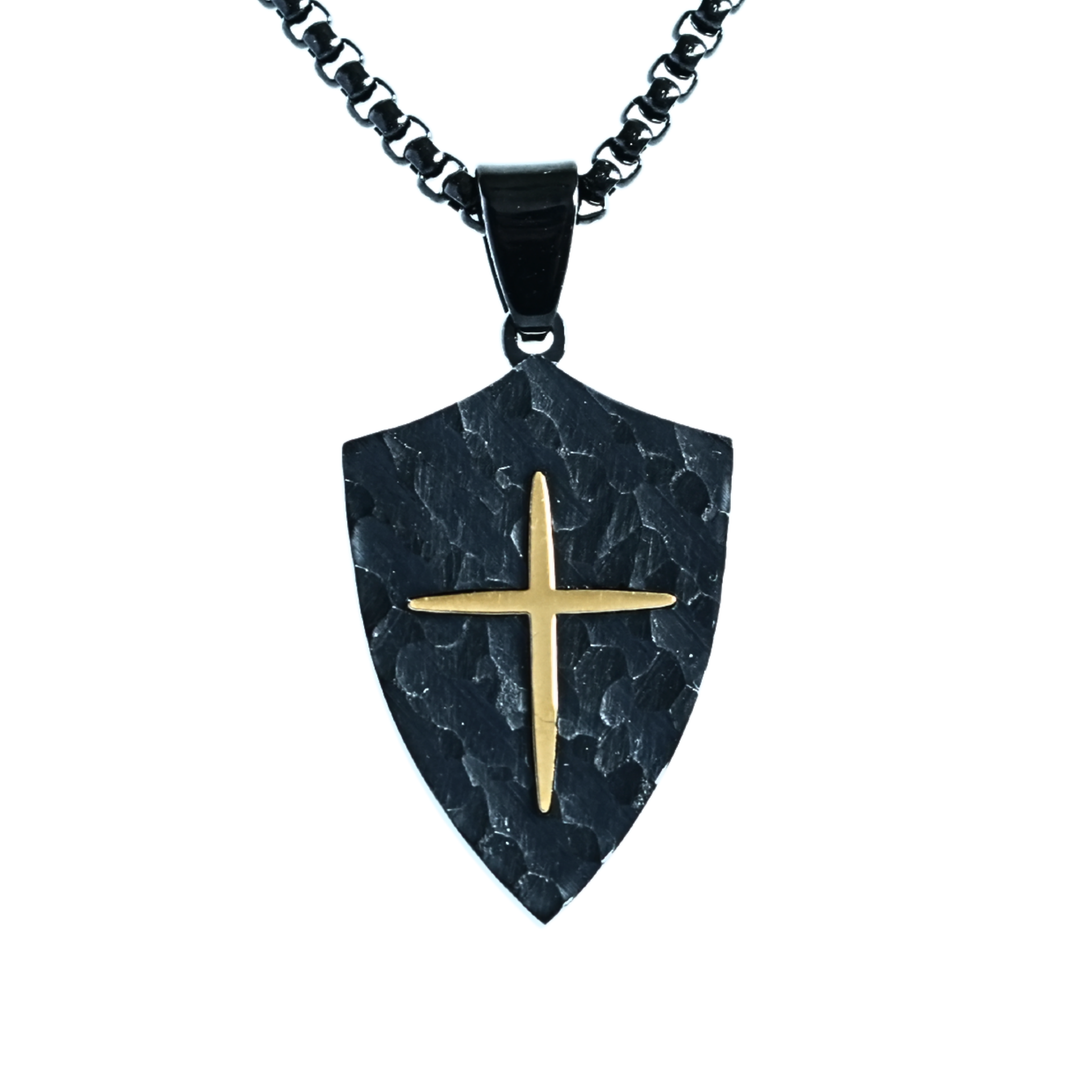 Hammered black shield pendant with raised gold-tone cross. Stainless steel, waterproof & hypoallergenic. Matching black chain and gift pouch included.