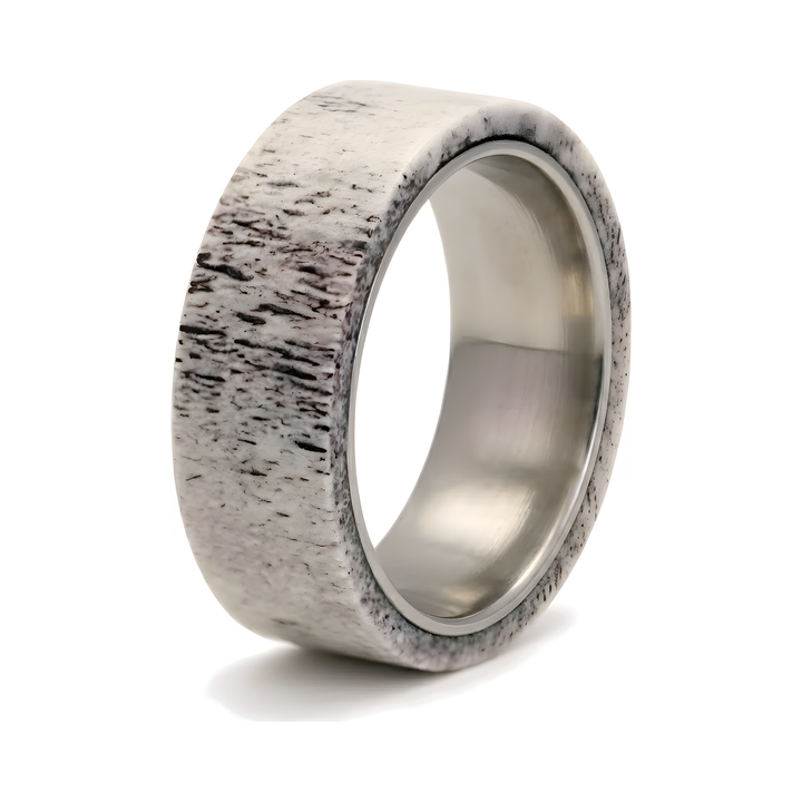 Antler & Titanium Band, isolated on white showing the textured antler exterior and polished titanium interior