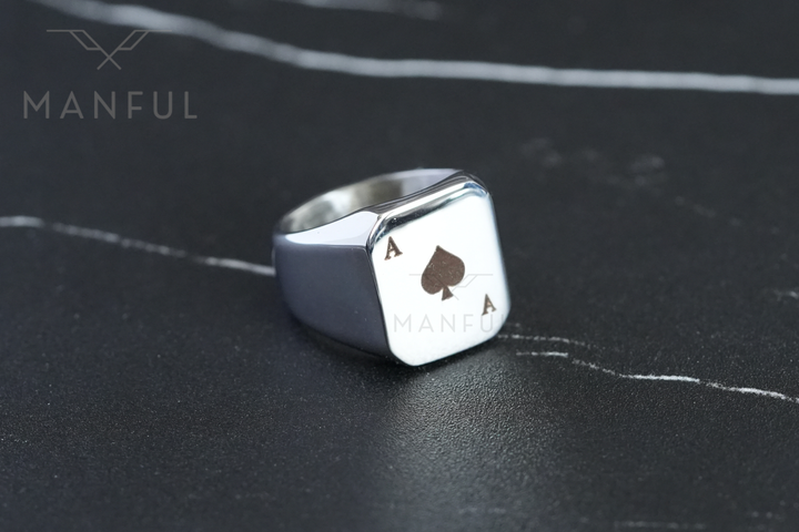 Ace Of Spades Signet Ring, resting on a dark marble surface with Manful branding visible