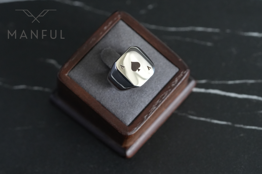 Ace Of Spades Signet Ring, displayed upright in an open leather ring box on dark marble