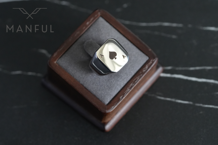 Ace Of Spades Signet Ring, displayed upright in an open leather ring box on dark marble