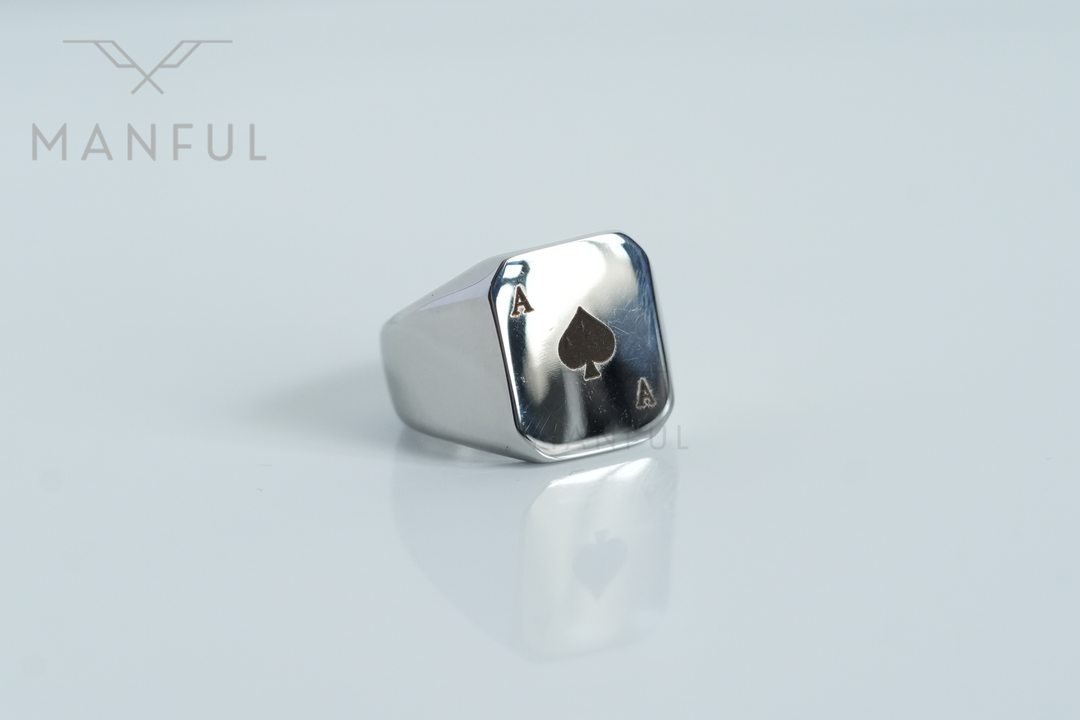 Ace Of Spades Signet Ring, angled close-up on a pale grey background with a soft reflection