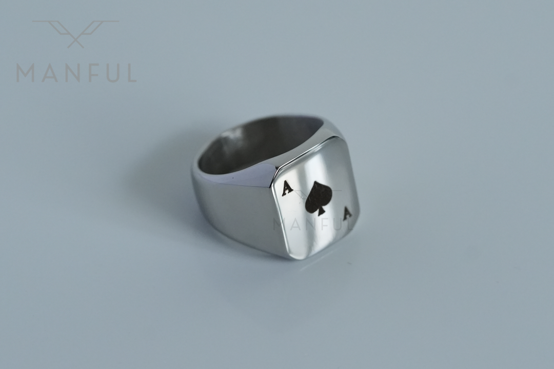 Ace Of Spades Signet Ring, extreme close-up on a pale grey background showing band and face