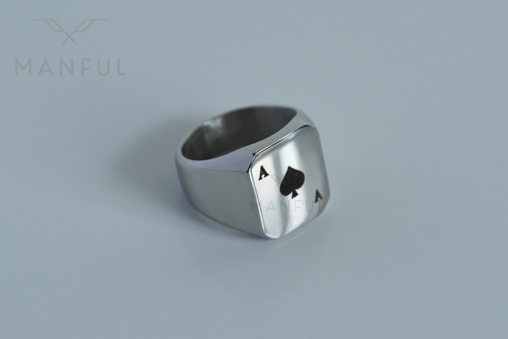 Ace Of Spades Signet Ring, extreme close-up on a pale grey background showing band and face