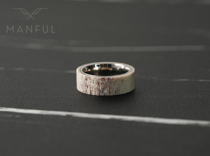 Antler & Titanium Band, standing front-on against a dark marble surface