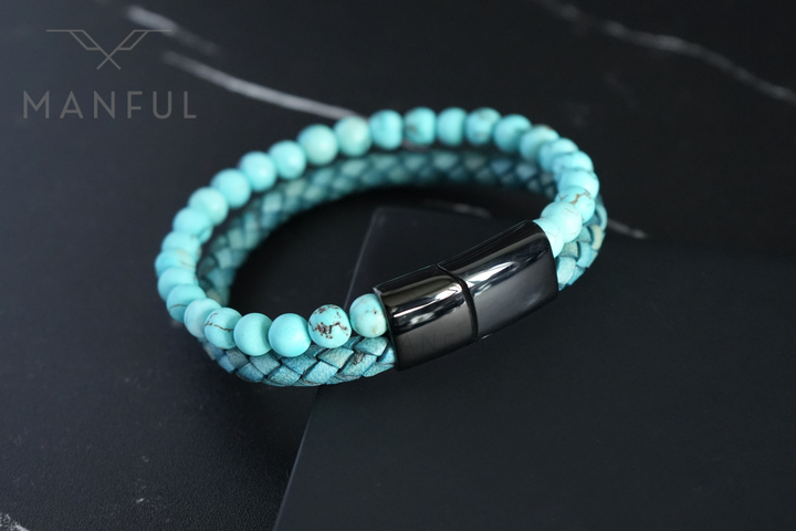 Aqua Bead And Leather Bracelet, coiled on dark marble with the beads and braided bands visible