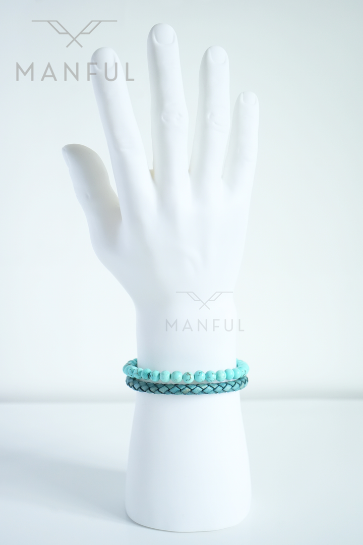 Aqua Bead And Leather Bracelet, stacked with a darker woven bracelet on a white mannequin wrist