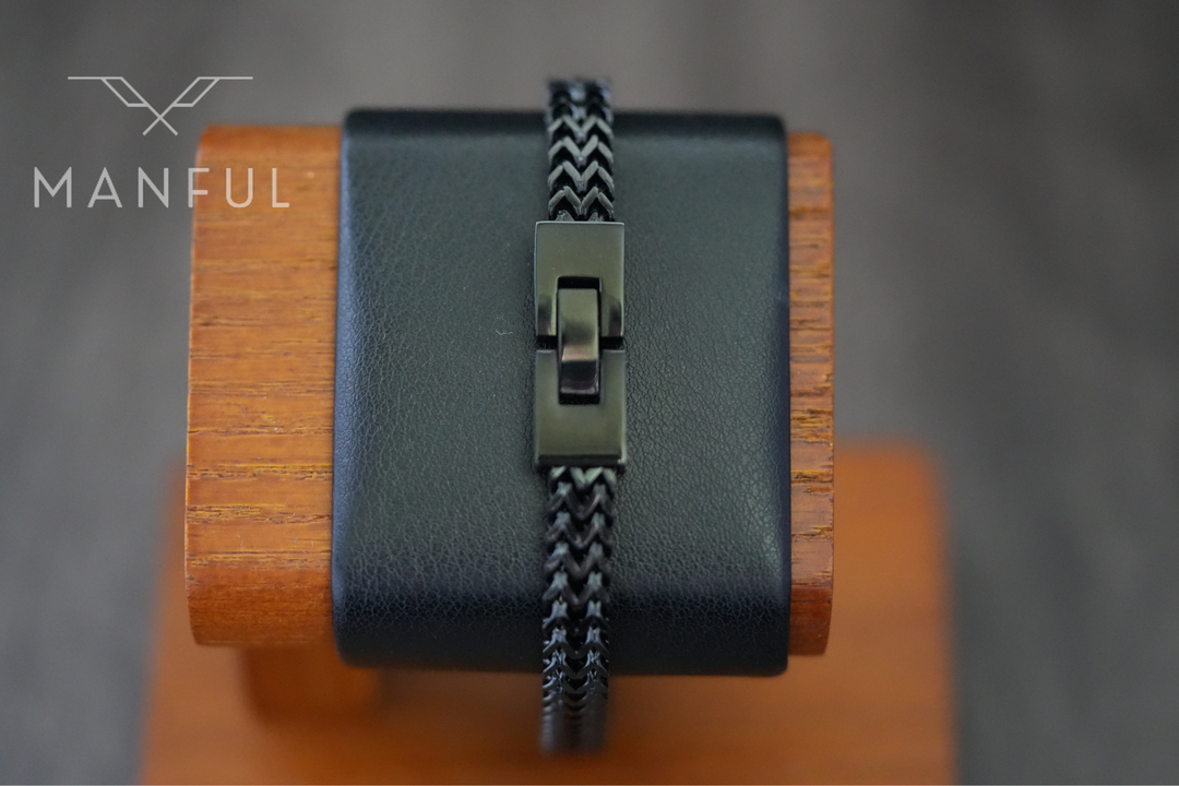 Foxtail Bracelet Black, close-up of the clasp fastened on a black leather wrist display