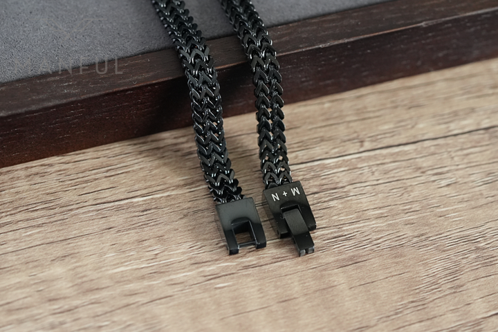 Foxtail Bracelet Black, close-up of both open clasp ends laid flat on wood