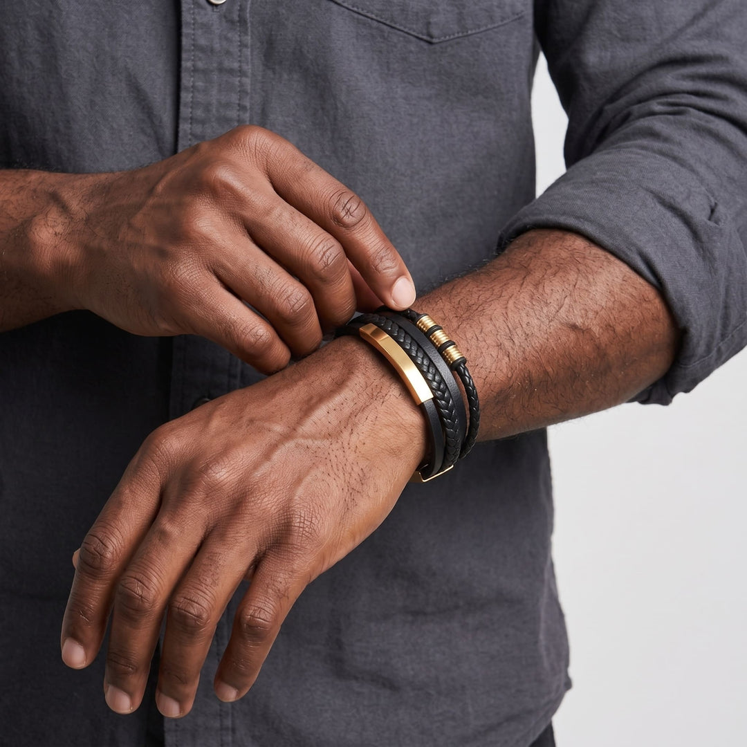 Black & Gold Leather Bracelet on a man's wrist as he adjusts it with his other hand