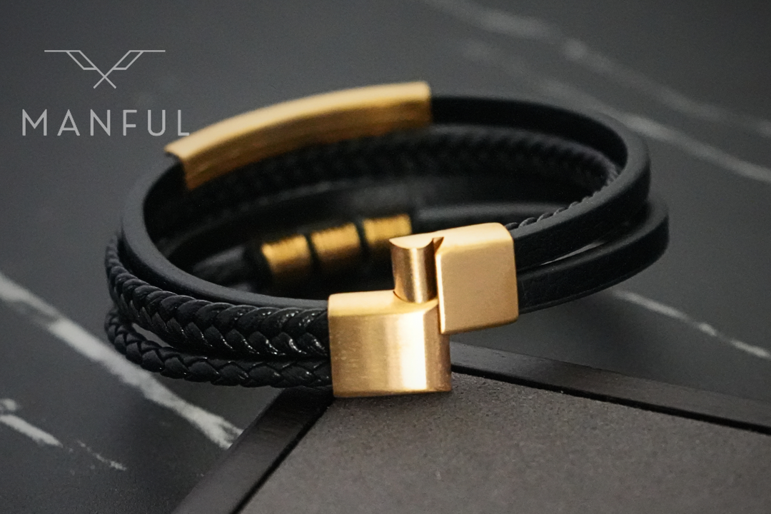 Black & Gold Leather Bracelet, close up on the gold magnetic clasp against dark marble