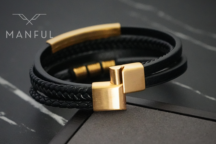 Black & Gold Leather Bracelet, close up on the gold magnetic clasp against dark marble