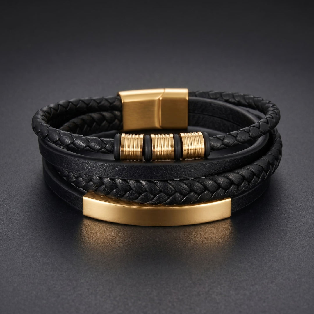 Black & Gold Leather Bracelet lying on a dark charcoal surface