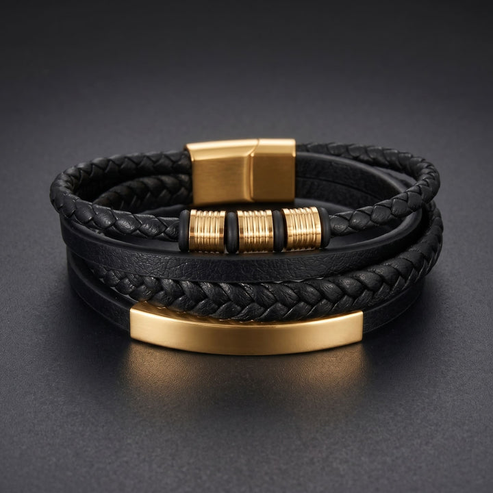 Black & Gold Leather Bracelet lying on a dark charcoal surface