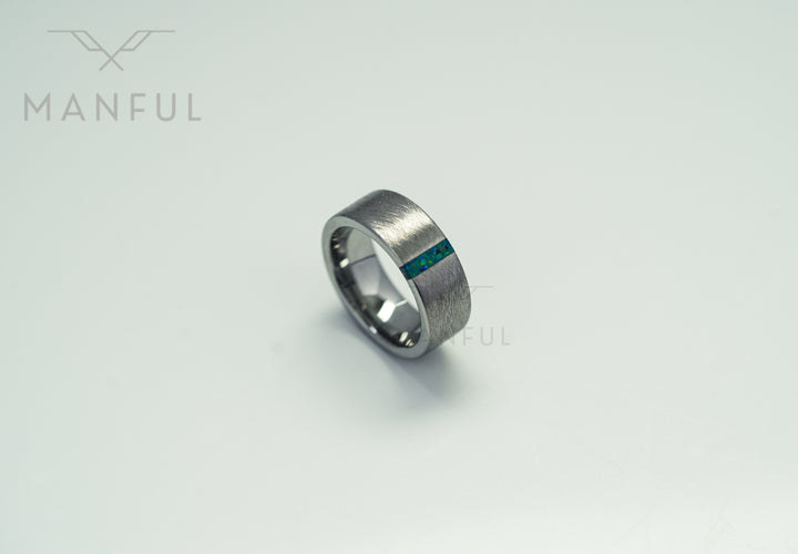 Black & Green Opal Line Tungsten Band, lying flat on a plain white background showing the inlay