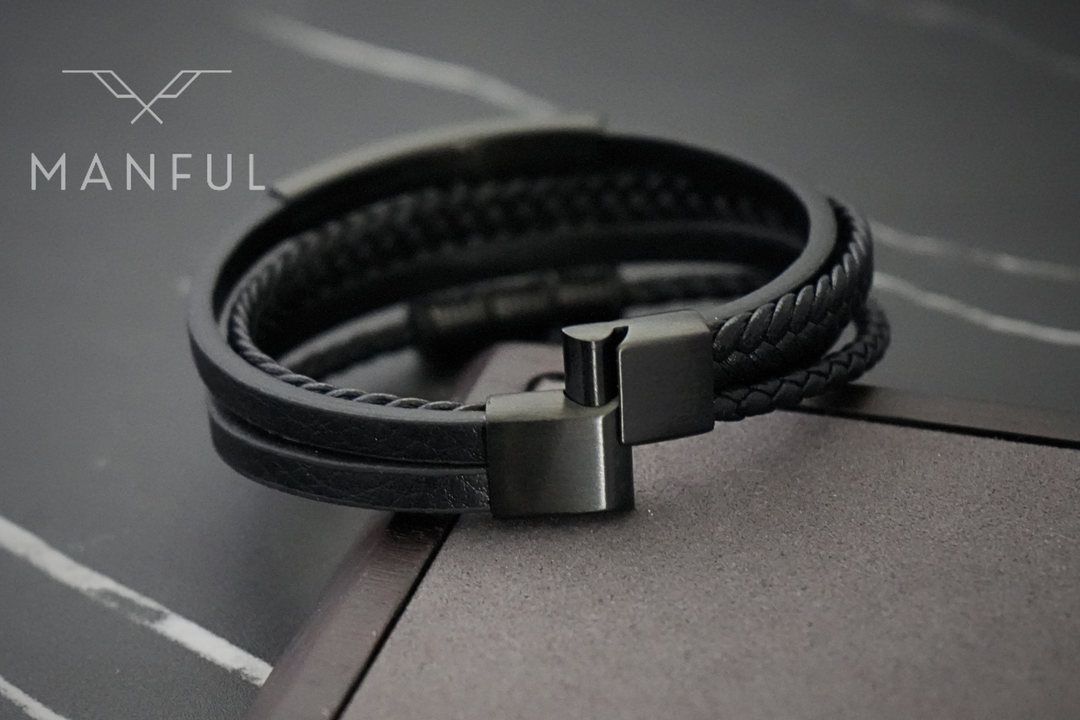 Black Leather Bracelet, close-up of the magnetic clasp resting on a dark stone accent