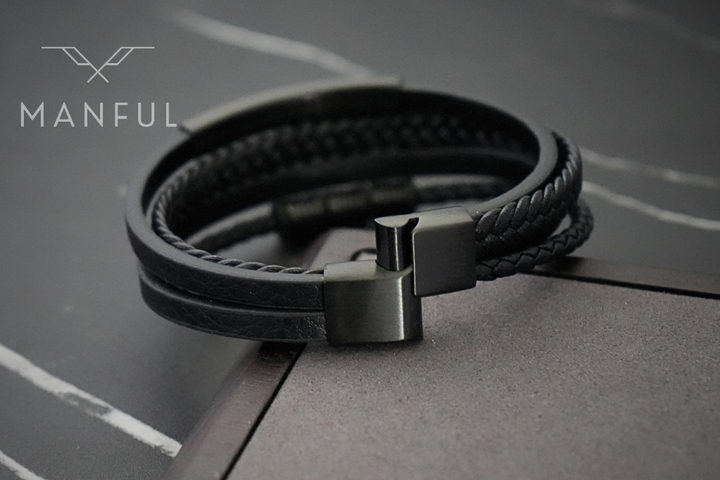 Black Leather Bracelet, close-up of the magnetic clasp resting on a dark stone accent