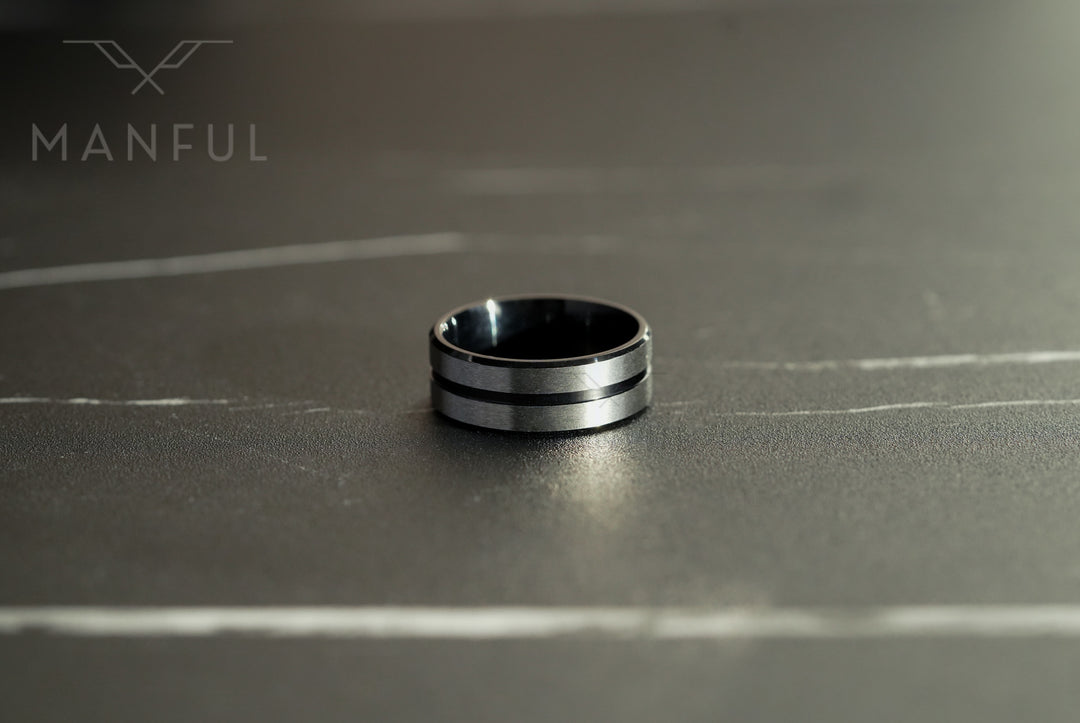 Black Onyx and Silver Band, resting on a dark marble surface showing two thin silver lines on black
