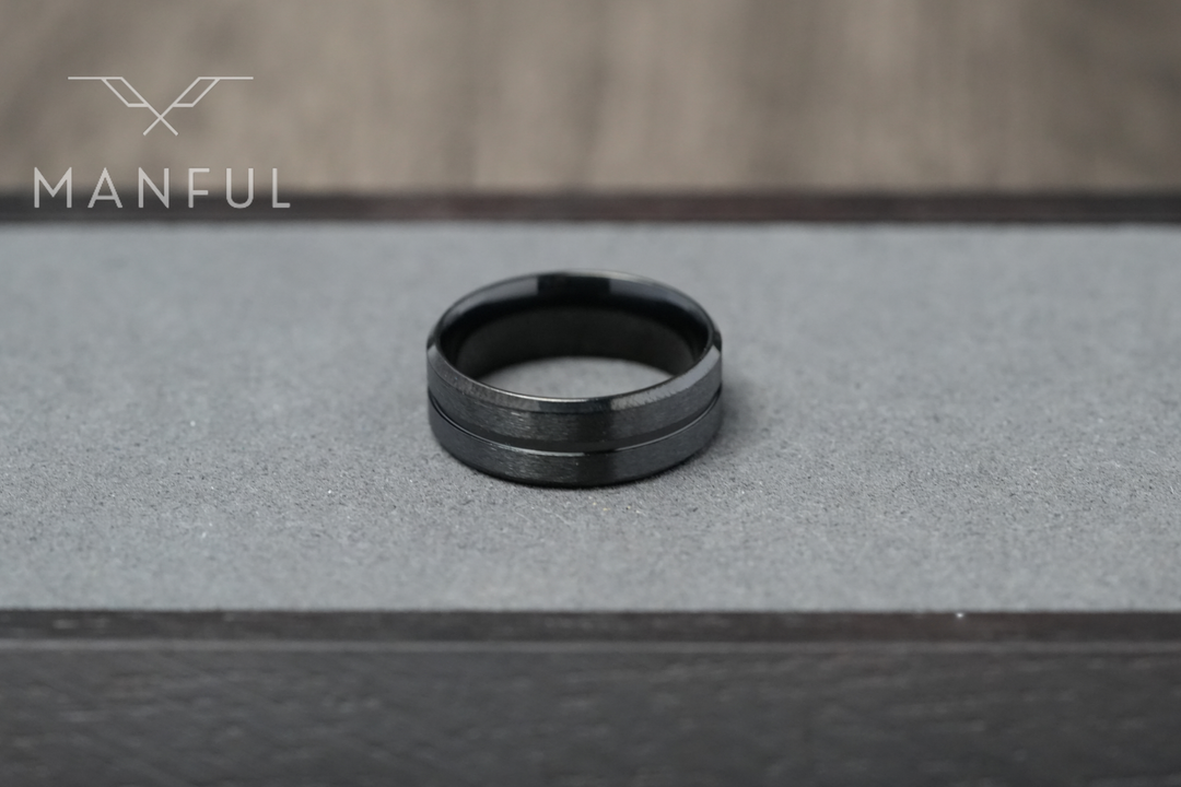 Black Onyx Band, set on a grey display platform framed by dark wood edges