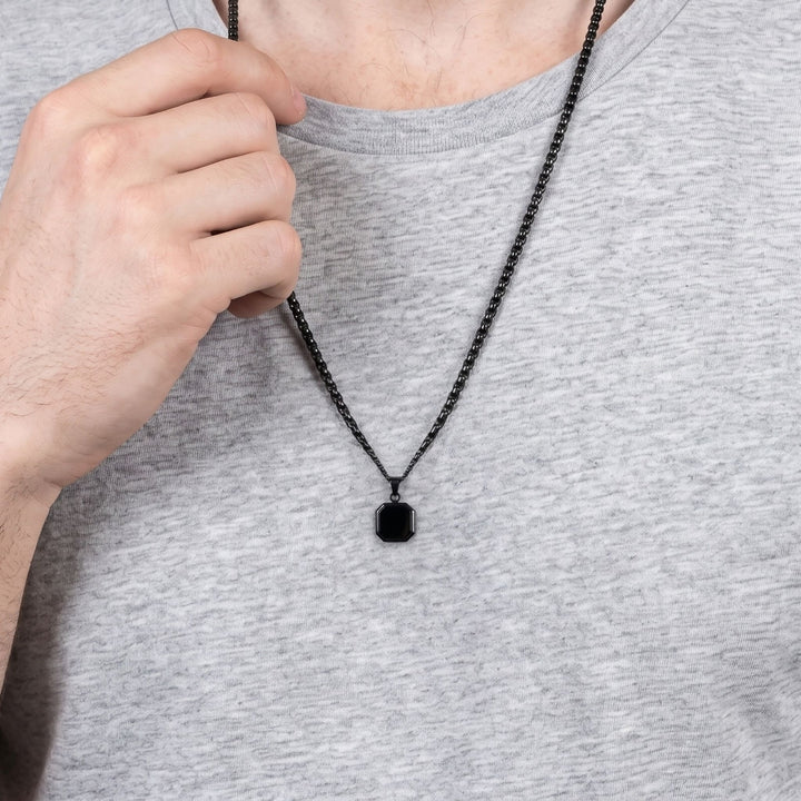 Onyx Square Necklace (Black) on a man's chest as he holds the chain near his collar