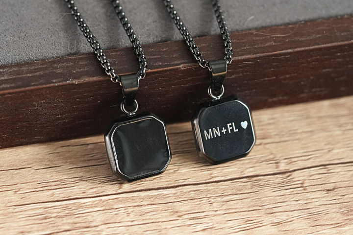 Onyx Square Necklace Black, shown as a plain and a heart-engraved pendant side by side on wood