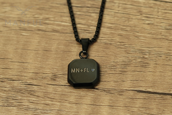 Onyx Square Necklace Black, flat lay on a wood surface with a custom engraved message