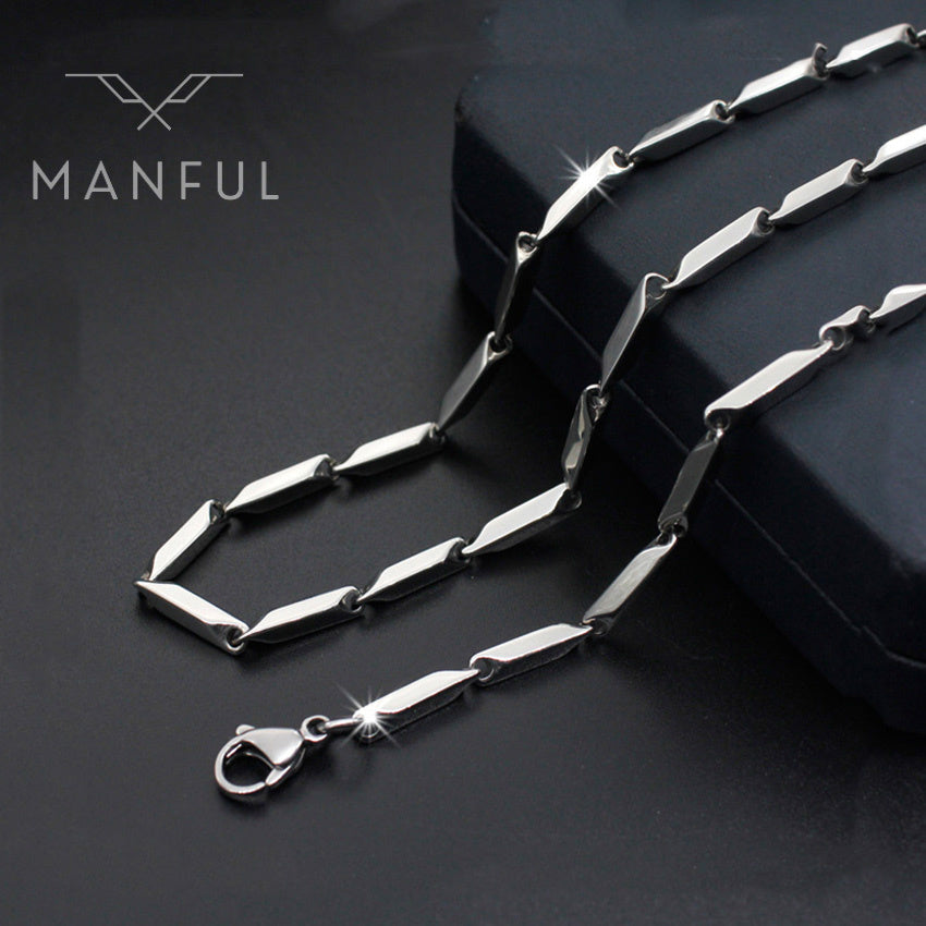 Block Chain Necklace, draped over a dark box prop with a close-up on the clasp