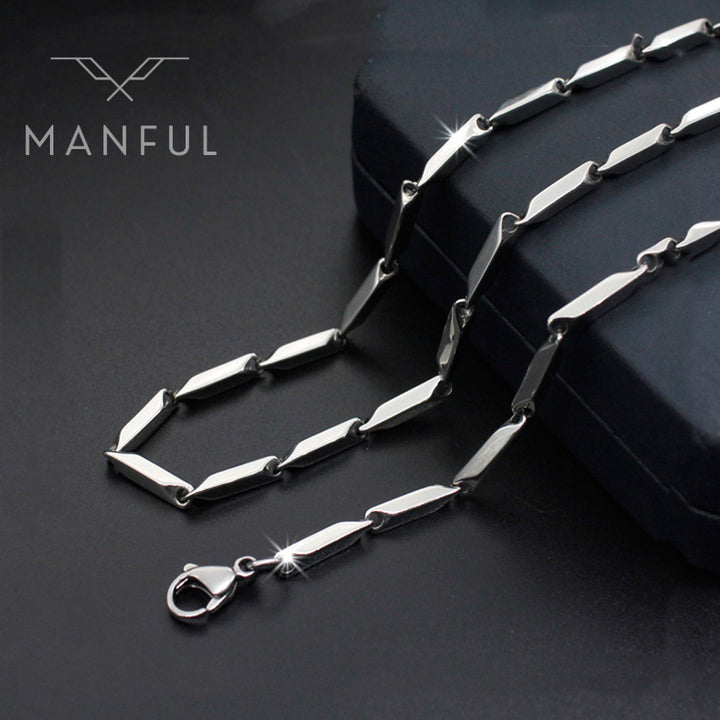 Block Chain Necklace, draped over a dark box prop with a close-up on the clasp