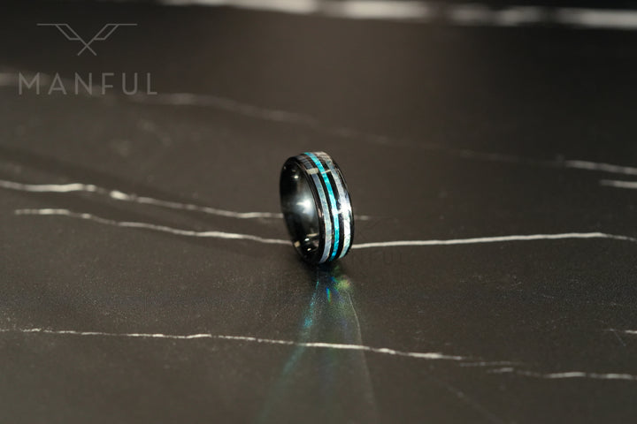 Blue Crystal Ring, standing upright on dark marble with light reflecting off the band