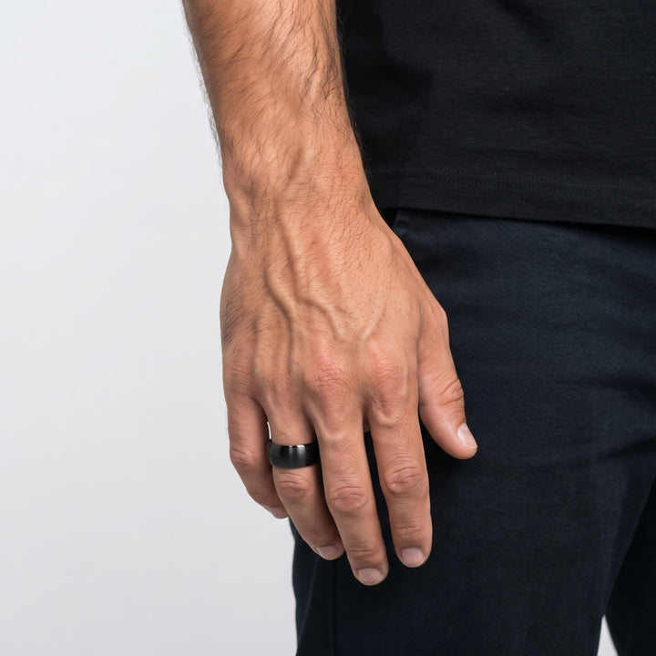 Brushed Titanium Band (Black) on a man's finger, his hand hanging at his side