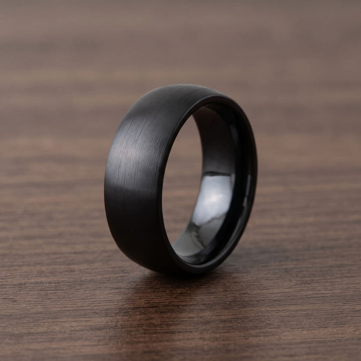 Brushed Titanium Band (Black) standing on a walnut table