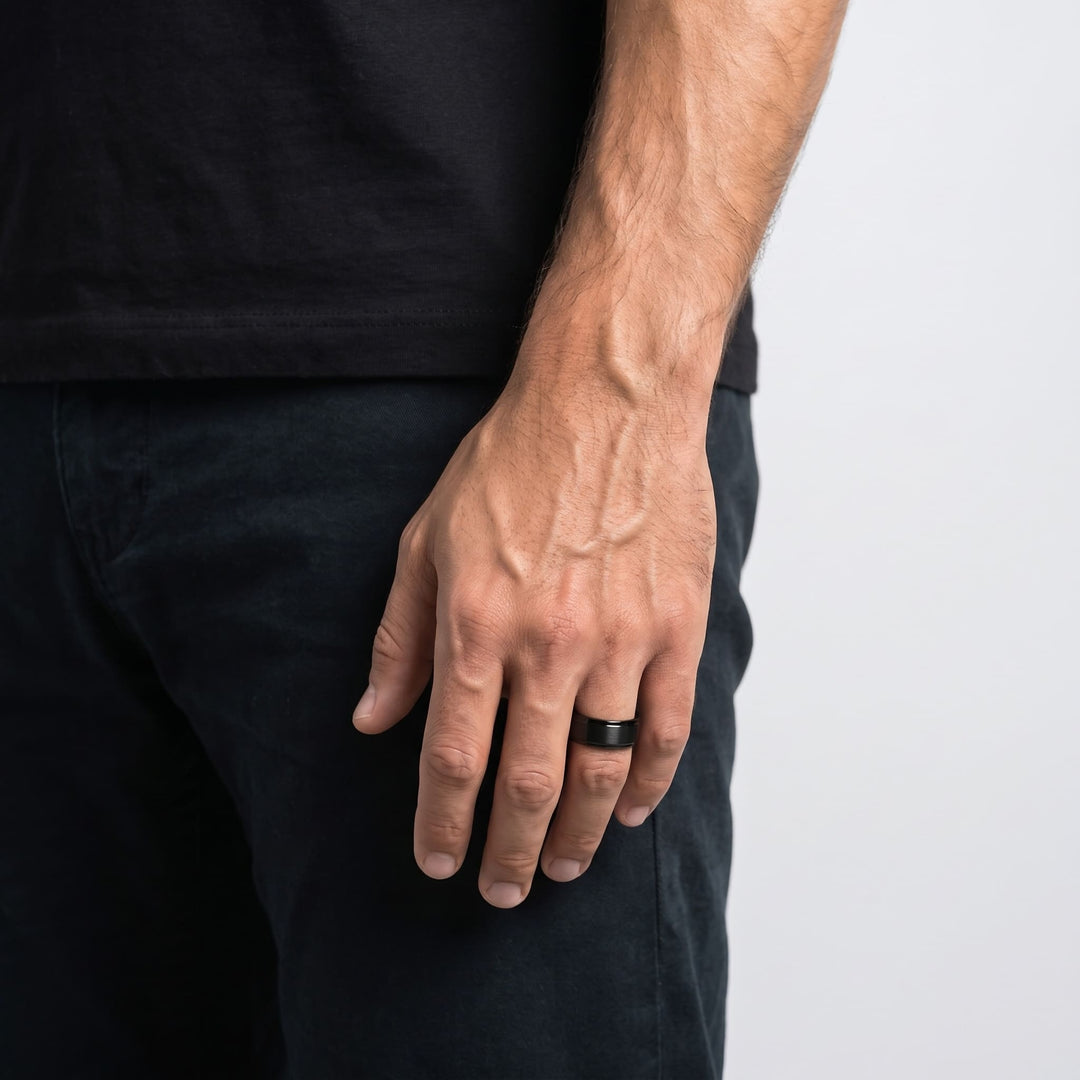 Brushed Tungsten Band (Black) worn on a man's ring finger, his hand relaxed at his side