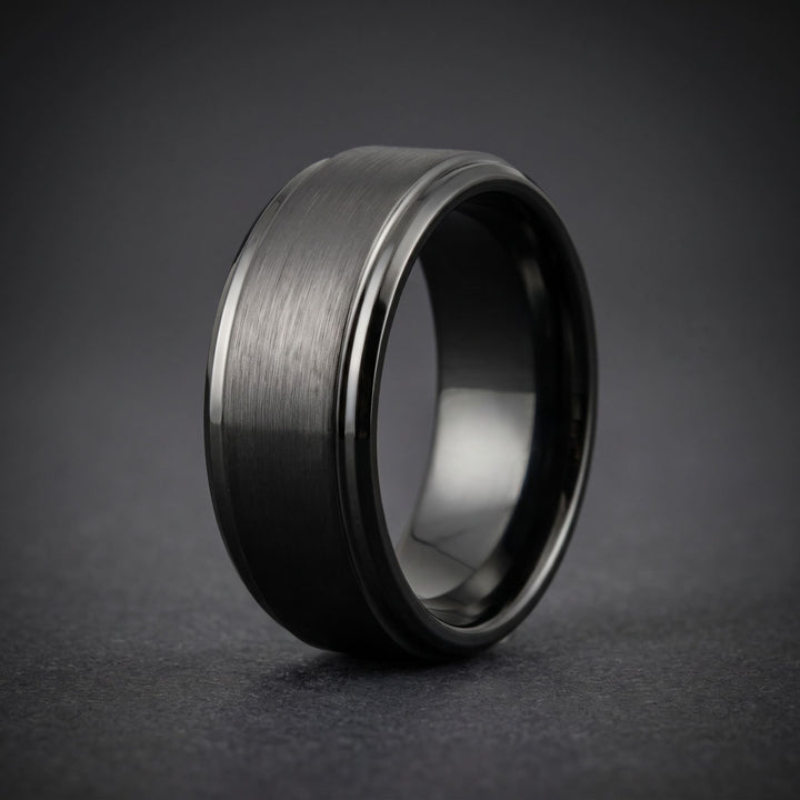 Brushed Tungsten Band (Black) standing upright on matte charcoal