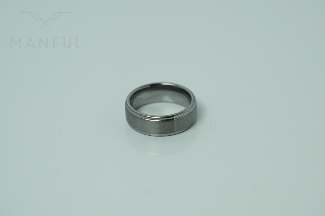 Brushed Tungsten Band Silver, lying on a light background in straight side view