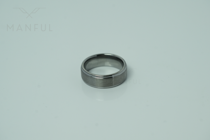 Brushed Tungsten Band Silver, lying on a light background in straight side view