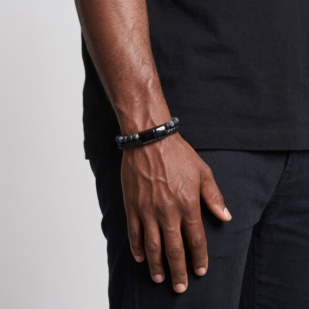 Charcoal Bead And Leather Bracelet on a man's wrist, his arm relaxed at his side