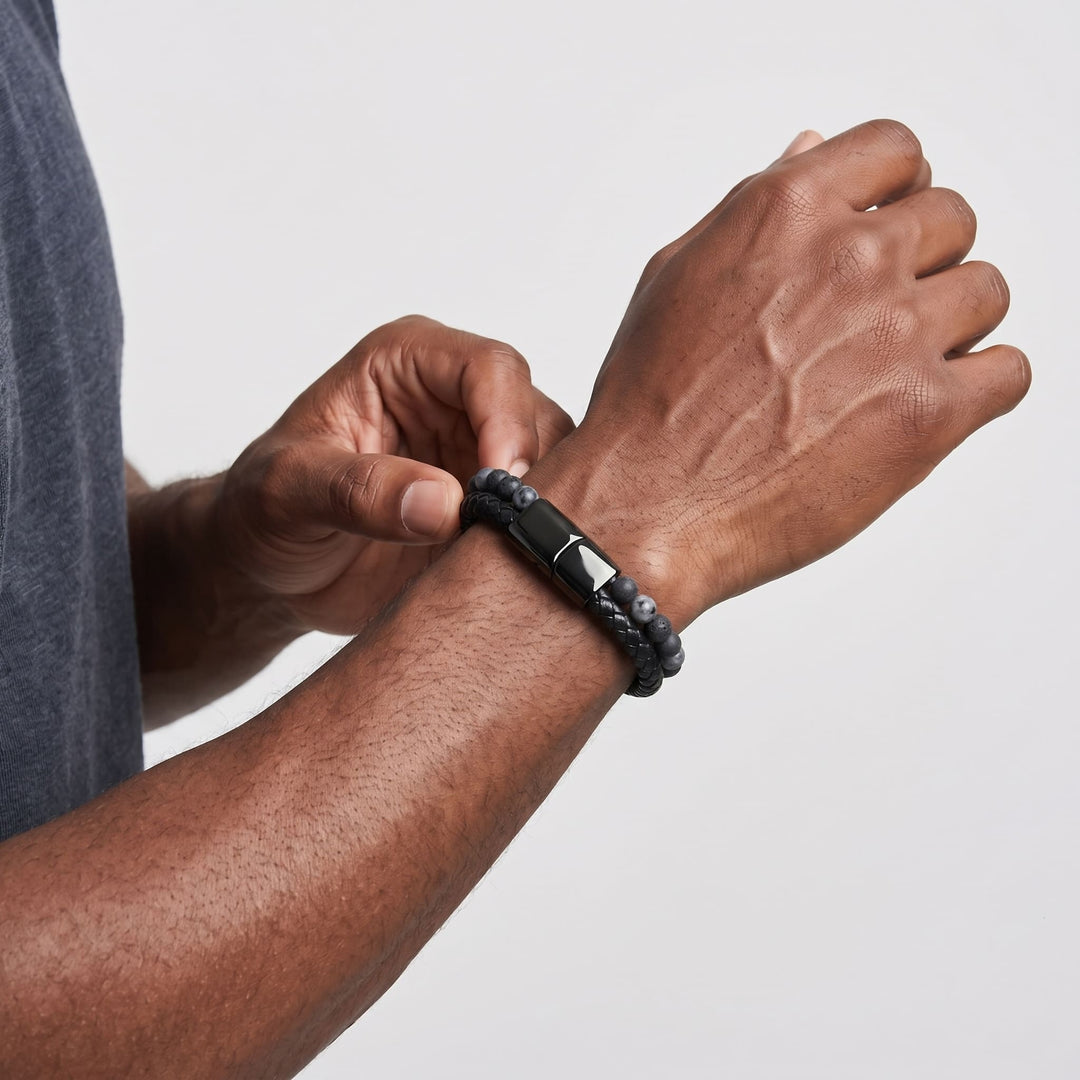 Charcoal Bead And Leather Bracelet on a man's wrist as he adjusts it with his other hand