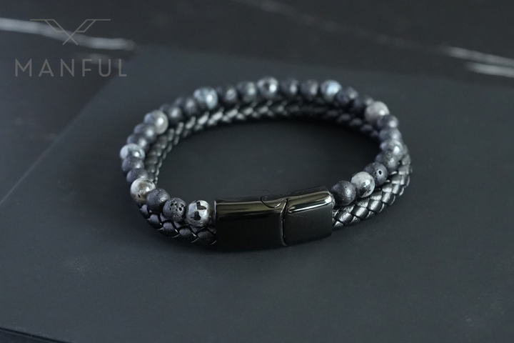 Charcoal Bead And Leather Bracelet, laid on dark slate with the plain black clasp facing forward