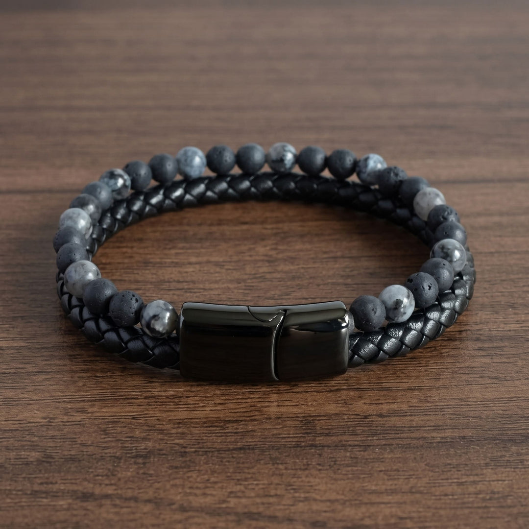 Charcoal Bead And Leather Bracelet on a walnut table with the black clasp at the front