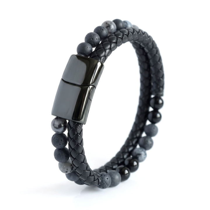 Charcoal Bead And Leather Bracelet standing on its edge with the black clasp and beads in view