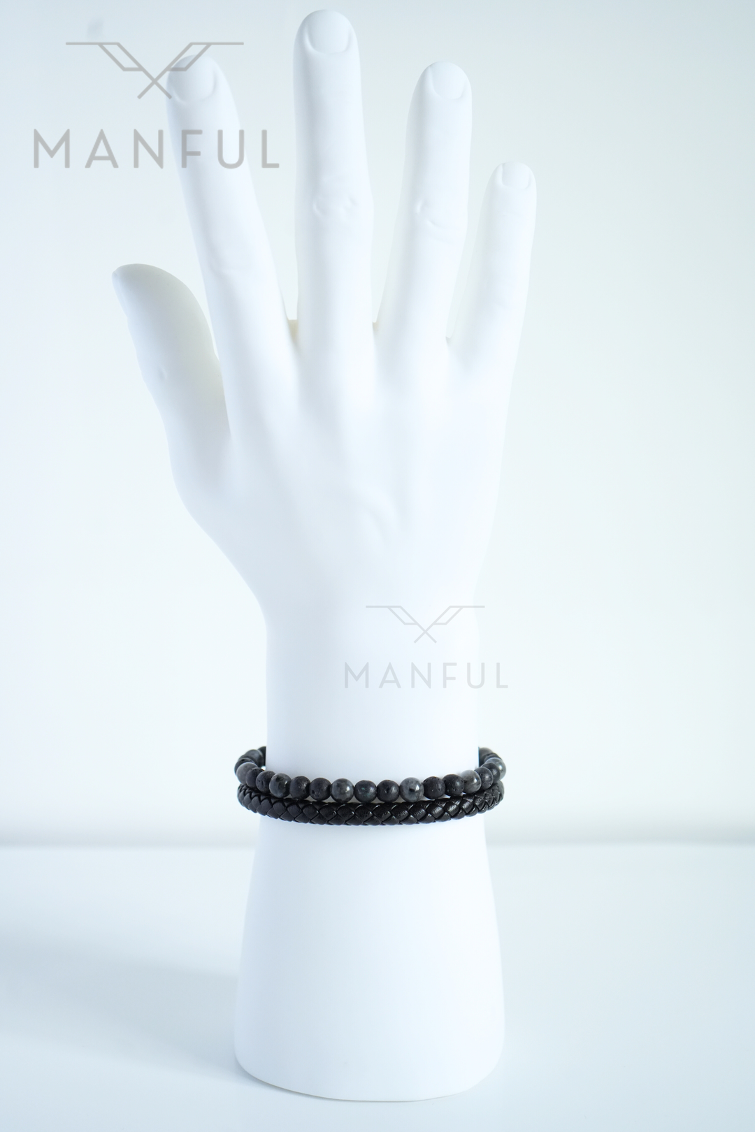 Charcoal Bead And Leather Bracelet, worn on a pale mannequin wrist, fingers together