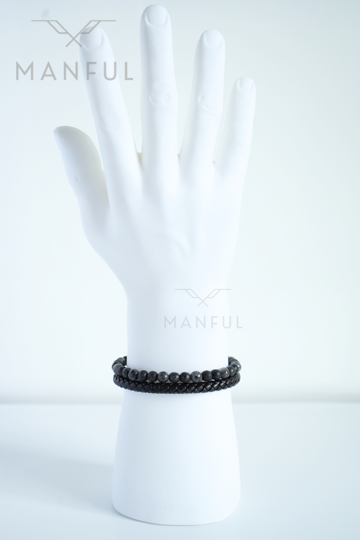 Charcoal Bead And Leather Bracelet, worn on a pale mannequin wrist, fingers together