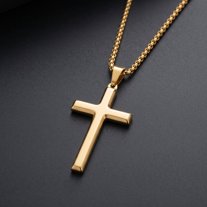 Cross Pendant Necklace (Gold) lying on a dark charcoal surface