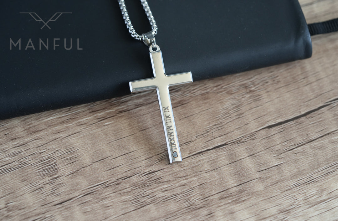 Cross Pendant Necklace Silver, resting on a wood surface with roman numeral engraving visible