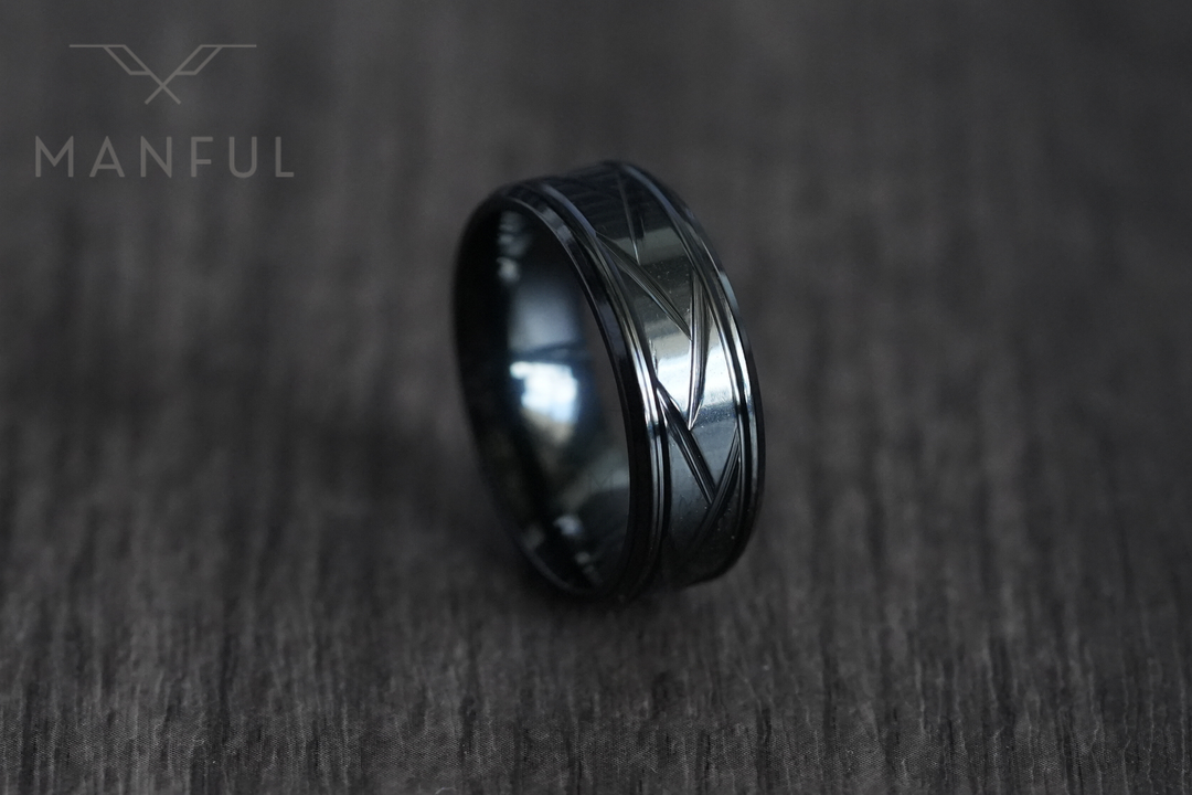 Crosscut Band Black, tilted on a dark wood-grain surface