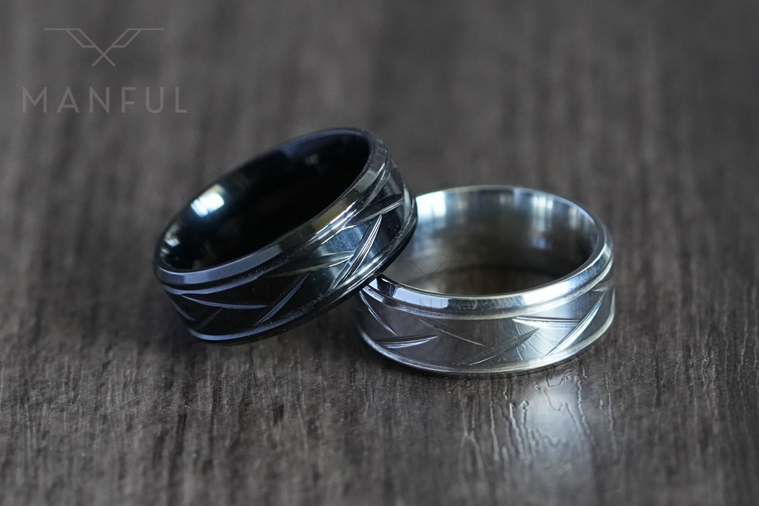 Crosscut Band Black, leaning against its silver colourway on a wood surface