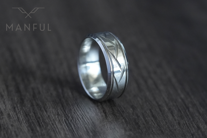 Crosscut Band Silver, standing upright in close focus on a dark wood surface
