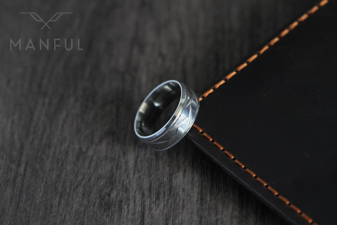 Crosscut Band Silver, propped against the stitched edge of a leather notebook