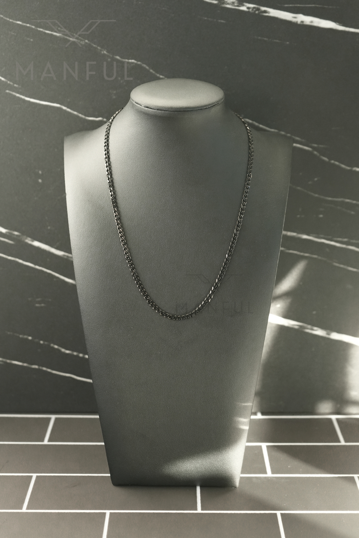 Cuban Chain 3mm Black, displayed on a grey bust against a marble-tiled backdrop