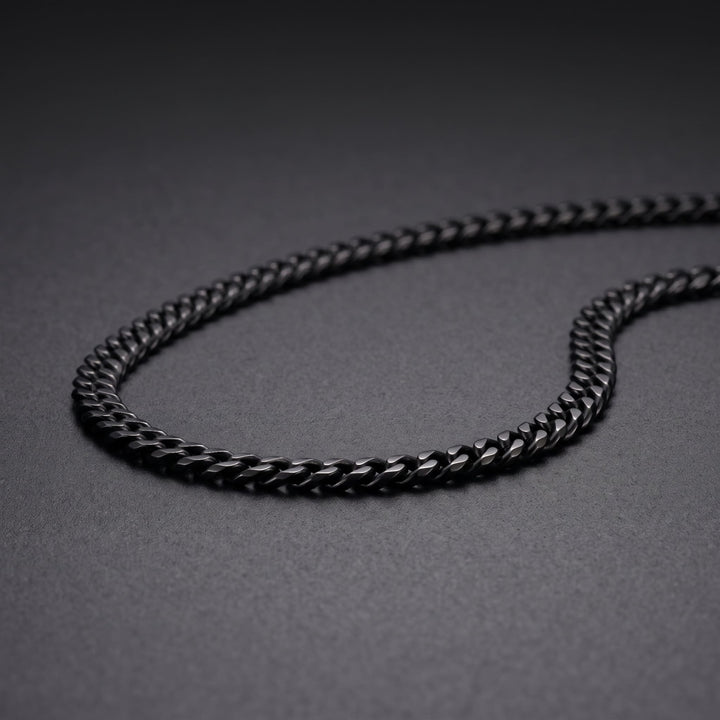 Cuban Chain 3mm Black on matte charcoal, close on the curb links